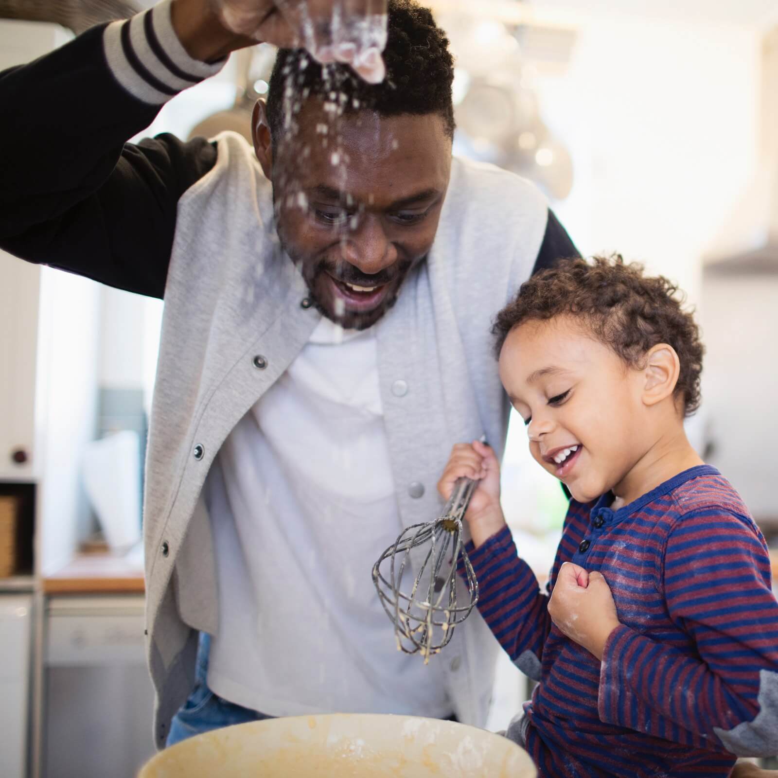 Father and child cooking together